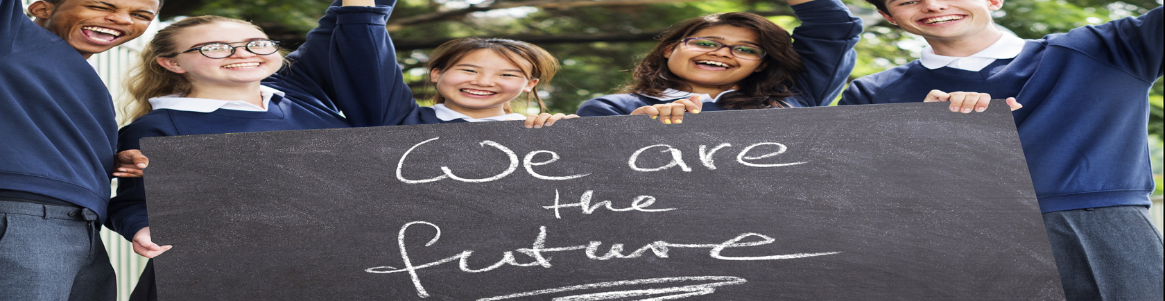 students holding a sign stating we are the future